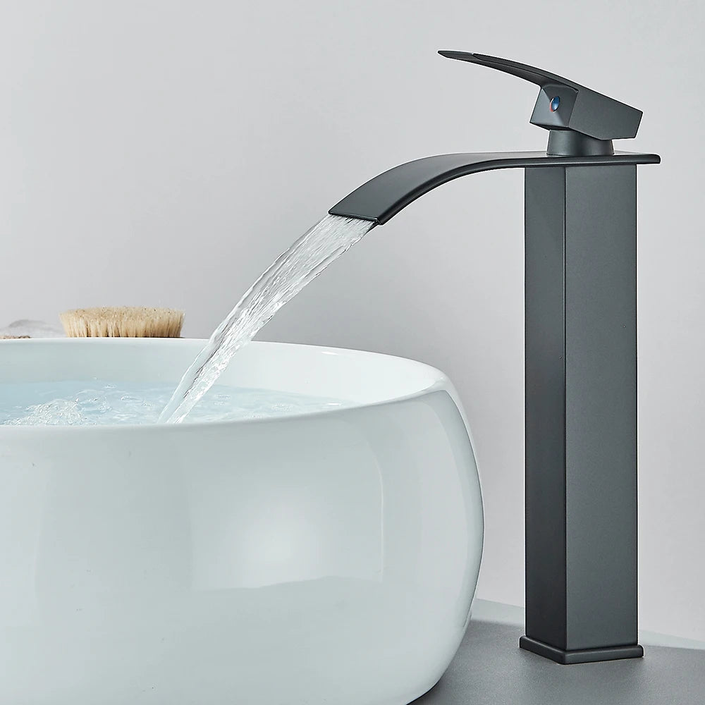 Robinet salle de bain noir long, eau limpide coule cascade, lavabo blanc sphérique, brosse