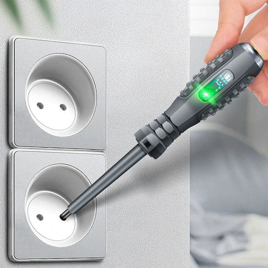 main de femme teste prises electriques blanche avec Tournevis stylo électrique, voyant vert