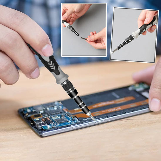 main d'un homme tient Tournevis 115 en 1 et repare smartphone ouvert, embouts magnetises