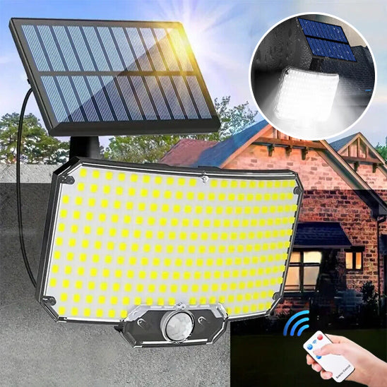 Lampe solaire extérieur avec panneau solaire de 234 led posée sur mur briques rouges, main tenant télécommande 