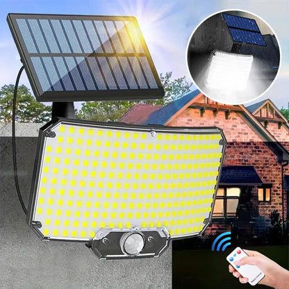Lampe solaire extérieur avec panneau solaire de 234 led posée sur mur briques rouges, main tenant télécommande 