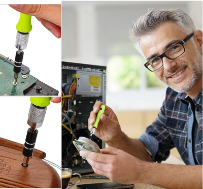 Tournevis de précision poignee verte ,réparation ordinateur par homme souriant avec lunette