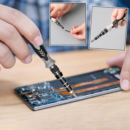 main d'un homme tient Tournevis 115 en 1  et repare smartphone ouvert, embouts magnetises
